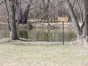 canoe access sign by a river
