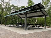 shelter with picnic tables under a roof
