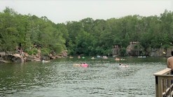 swimmers floating in a water filled quarry