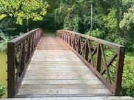 bridge made of wooden boards and metal rails