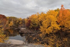 water filled quarry surrounded by colorful trees
