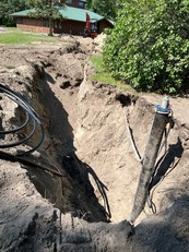 Trench in the ground from a water pipe to a building