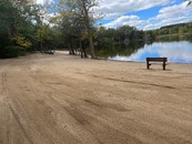 large sandy beach area near a lake
