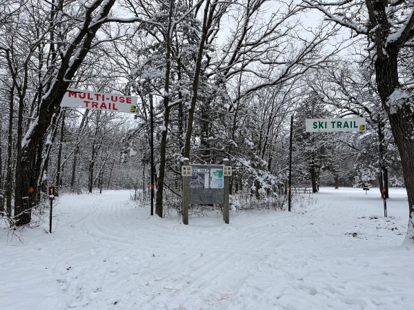 two snow covered trails with banners above 