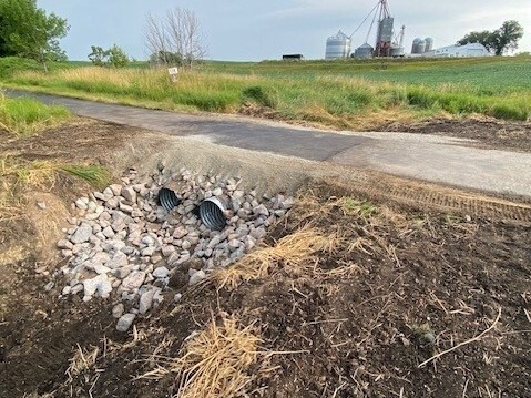 two culverts under a paved trail