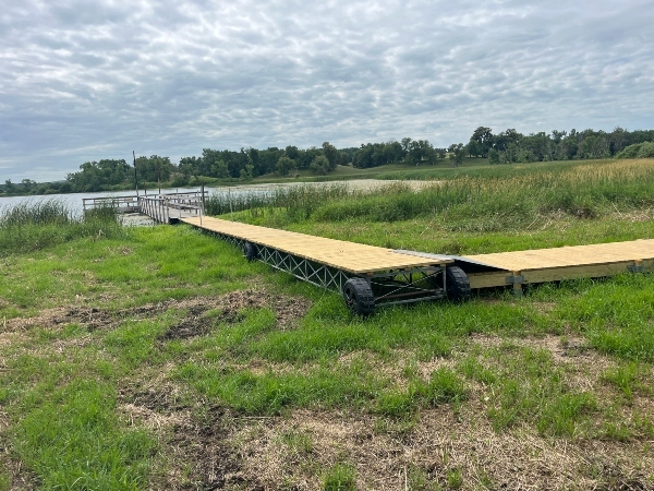 wooden boardwalk leads out to a fishing pier
