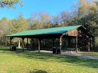 trees behind a picnic shelter 