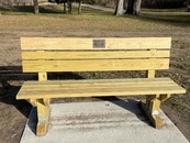 wooden bench on a cement slab
