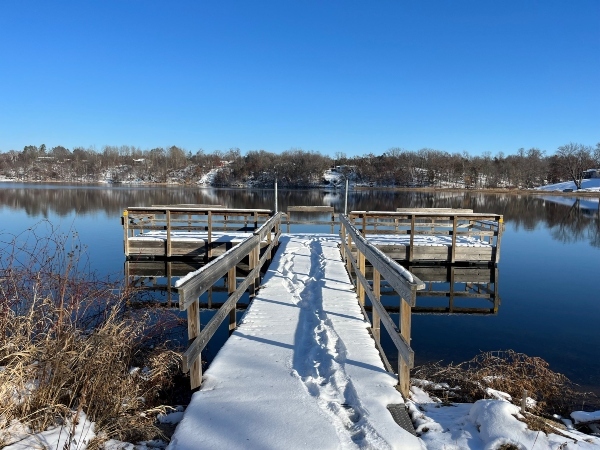 open water behind a snow covered pier