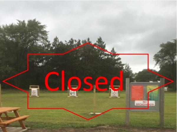 archery bags in a grassy area with CLOSED text across the photo