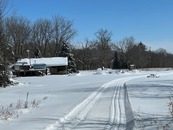 groomed trail near a snow covered building