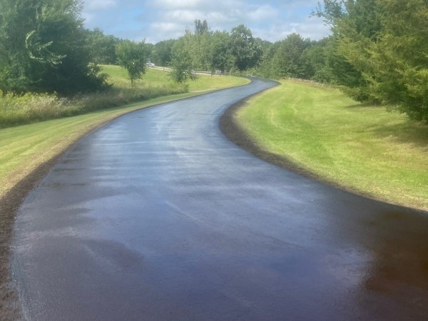 new seal coating on paved driveway