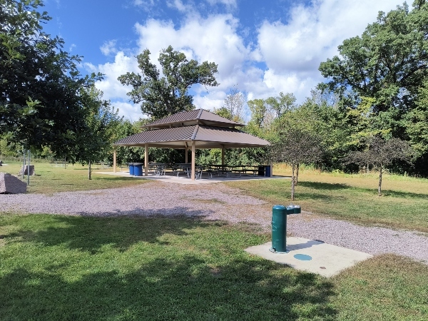 trails through grass leading to a shelter