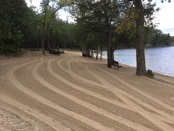 raked beach by lake