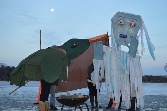Shingebiss the duck and the Wintermaker meet at the Phalen Freeze Fest pageant