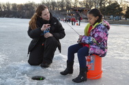Woman and child ice fishing