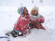 Two children play in snow