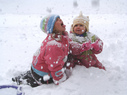 Two children play in snow