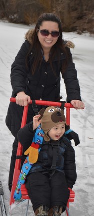 Woman and child on kicksleds