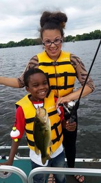 Free Family Fishing at Lake Phalen--adult and child holding up their fish