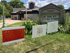 Story Stroll storybook signs in front of Langford Park Recreation Center