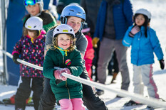 Youth with ski instructor on rope tow