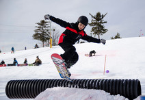 Youth snowboarder at Como Park Ski Center terrain park