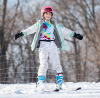 Youth with outstretched arms and big smile at Como Park Ski Center.