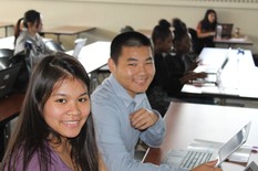 Two smiling Right Track youth at computers.