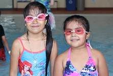 Two children wearing goggles at Great River Water Park.