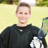 Youth lacrosse player smiling.