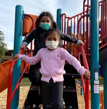Youth on a playground wearing masks