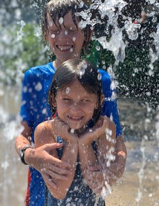 Two youth enjoying a splash pad