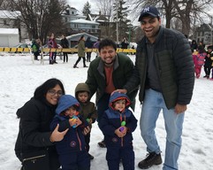 A smiling family at a snowy, spring egg hunt. 