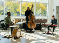 Musicians playing musical instruments at Frogtown Community Center as part of the Mobile Jazz Project. 