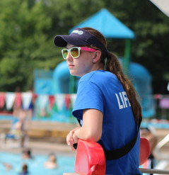 Lifeguard in a blue shirt and sunglasses