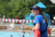 Lifeguard in a blue shirt and sunglasses