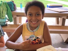 Girl holding up button