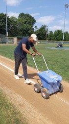 Parks Worker lining a baseball field