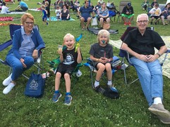 Family sitting in chairs at a Movie in the Park event