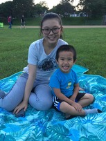 Two youth sitting on a blanket attending Movies in the Parks