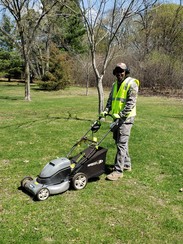 Parks Worker pushing lawn mower