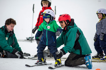 Youth learning to ski with ski instructors