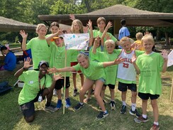 Youth in green shirts posing at the Amazing Race