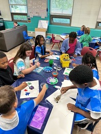 Group of youth painting at a table