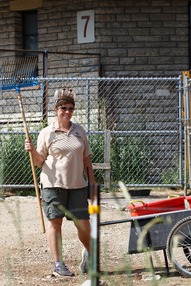 Zookeeper cleaning animal exhibit 