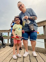 Family Fishing_adult and youth together showing off a caught fish