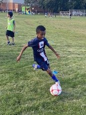 Boy dribbling soccer ball