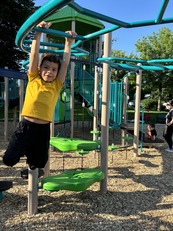 Youth on monkey bars