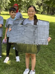 Youth dressed up in cardboard outfit at Amazing Race event_summer 2024